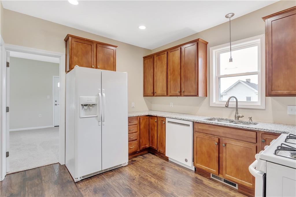 817 13th Street McKees Rocks, PA 15136 - Photo 7 of 18 Hardwood floors flow into the newly remodeled kitchen with a view to the den that could even be a first floor master bedroom if you chose.
