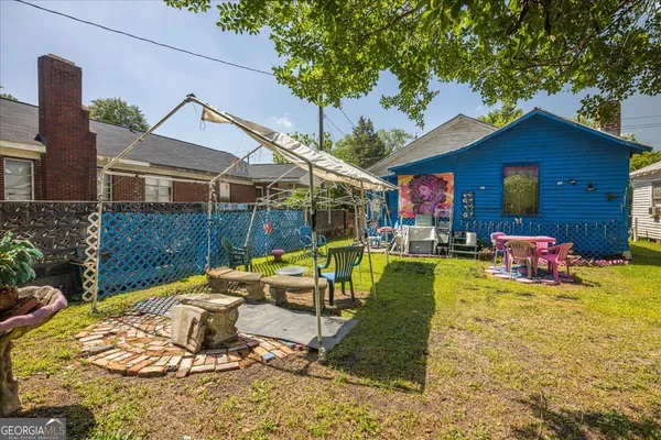 a view of a house with swimming pool and sitting area