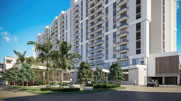 a view of a tall building next to a yard