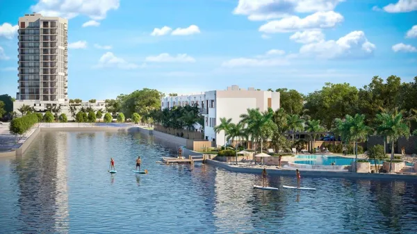 a blue swimming pool with outdoor seating and lake view