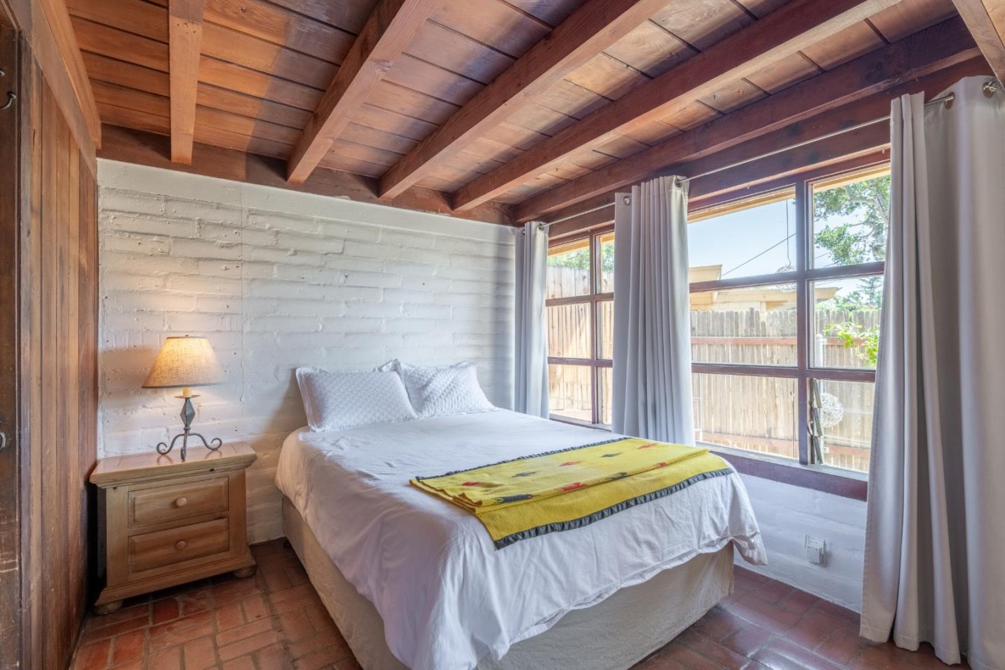 72 Los Laureles Grade Road Carmel Valley, CA 93924 - Photo 38 of 43 a bedroom with a bed and a lamp