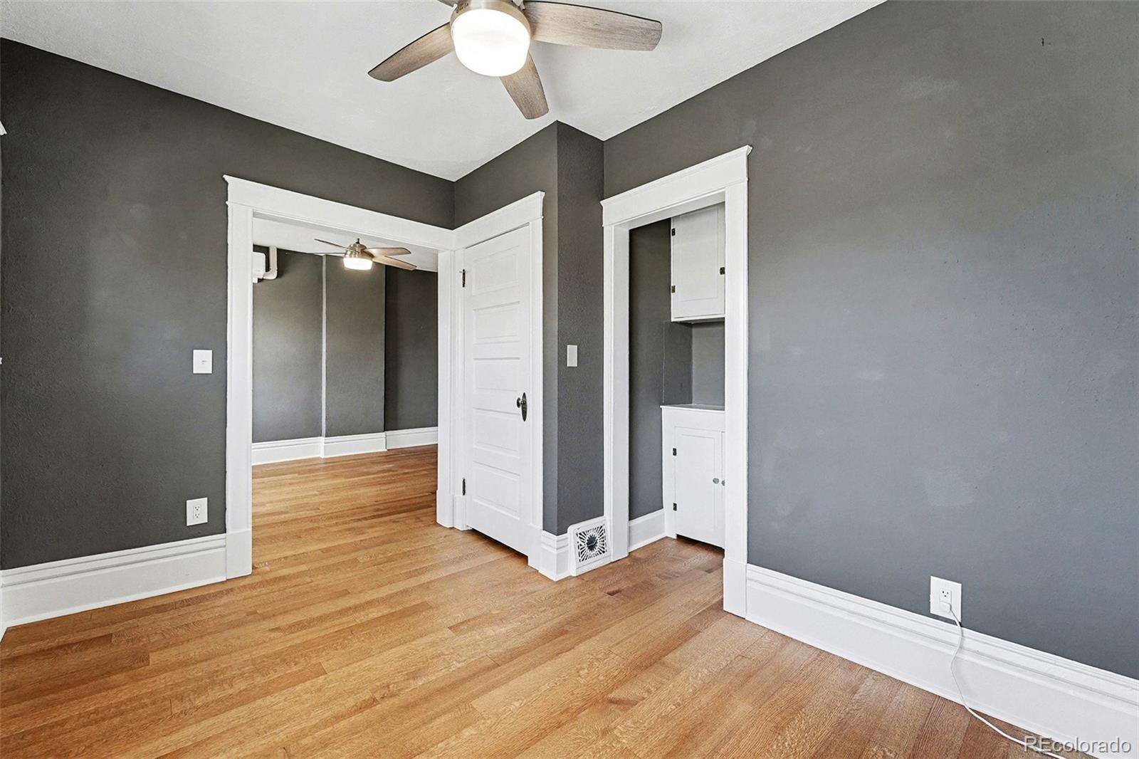 1419 Adams Street Denver, CO 80206 - Photo 22 of 34 wooden floor in an empty room with a window