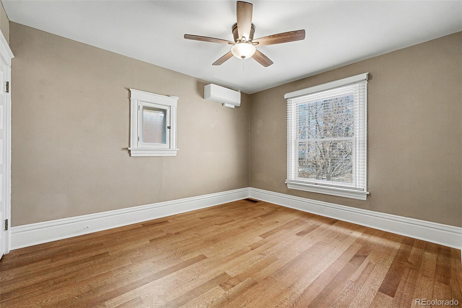 1419 Adams Street Denver, CO 80206 - Photo 24 of 34 a view of an empty room with a window and a chandelier fan