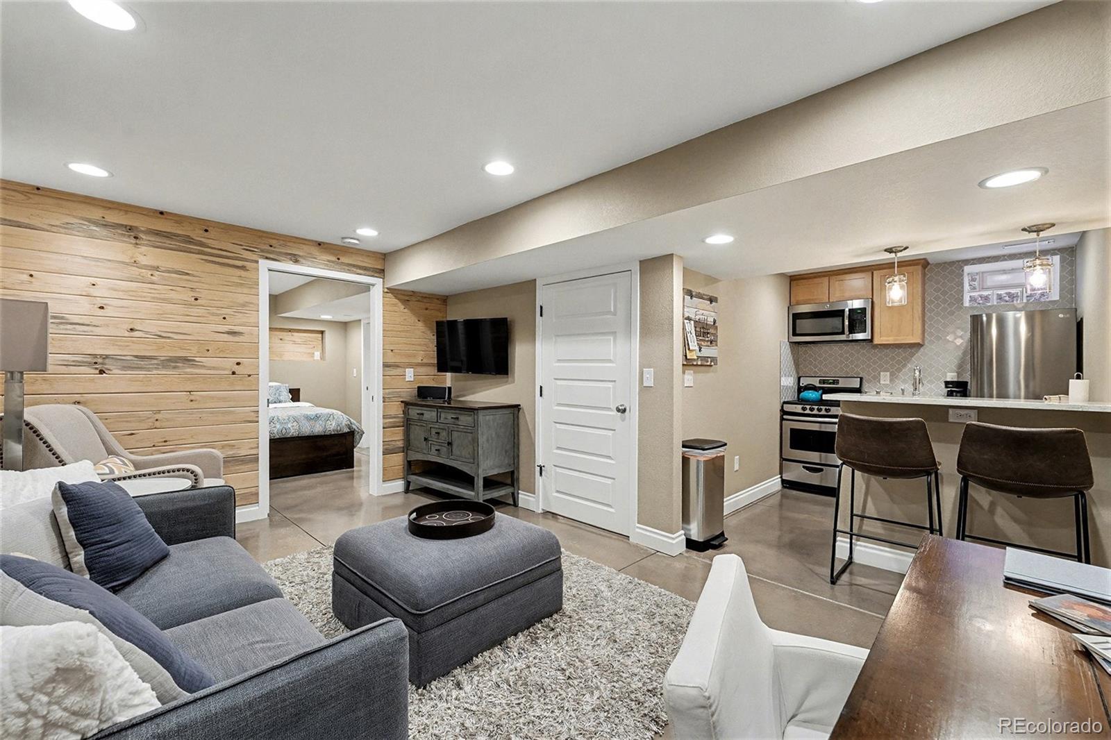 1419 Adams Street Denver, CO 80206 - Photo 27 of 34 a living room with furniture and a flat screen tv