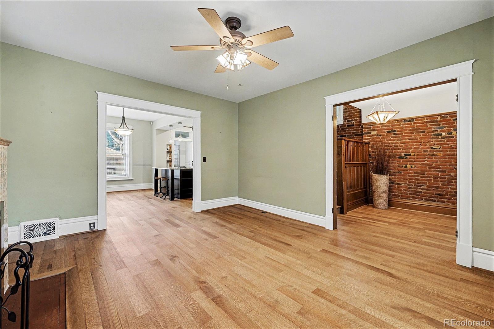 1419 Adams Street Denver, CO 80206 - Photo 7 of 34 wooden floor in an empty room with a window