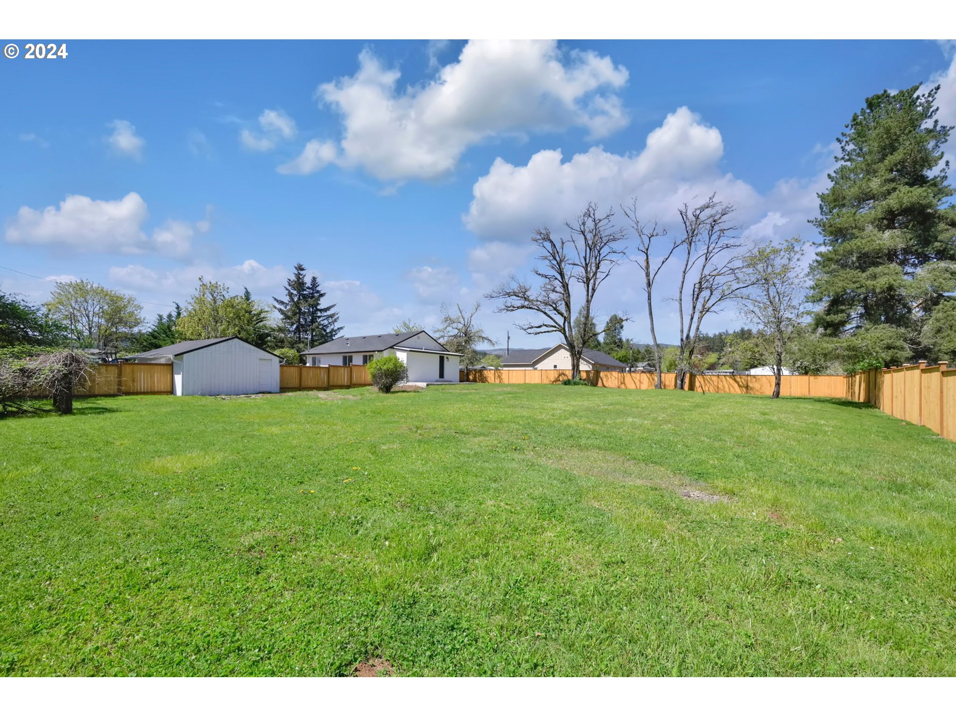 92045 Maple Lane Springfield, OR 97478 - Photo 17 of 21 a front view of a house with garden and trees