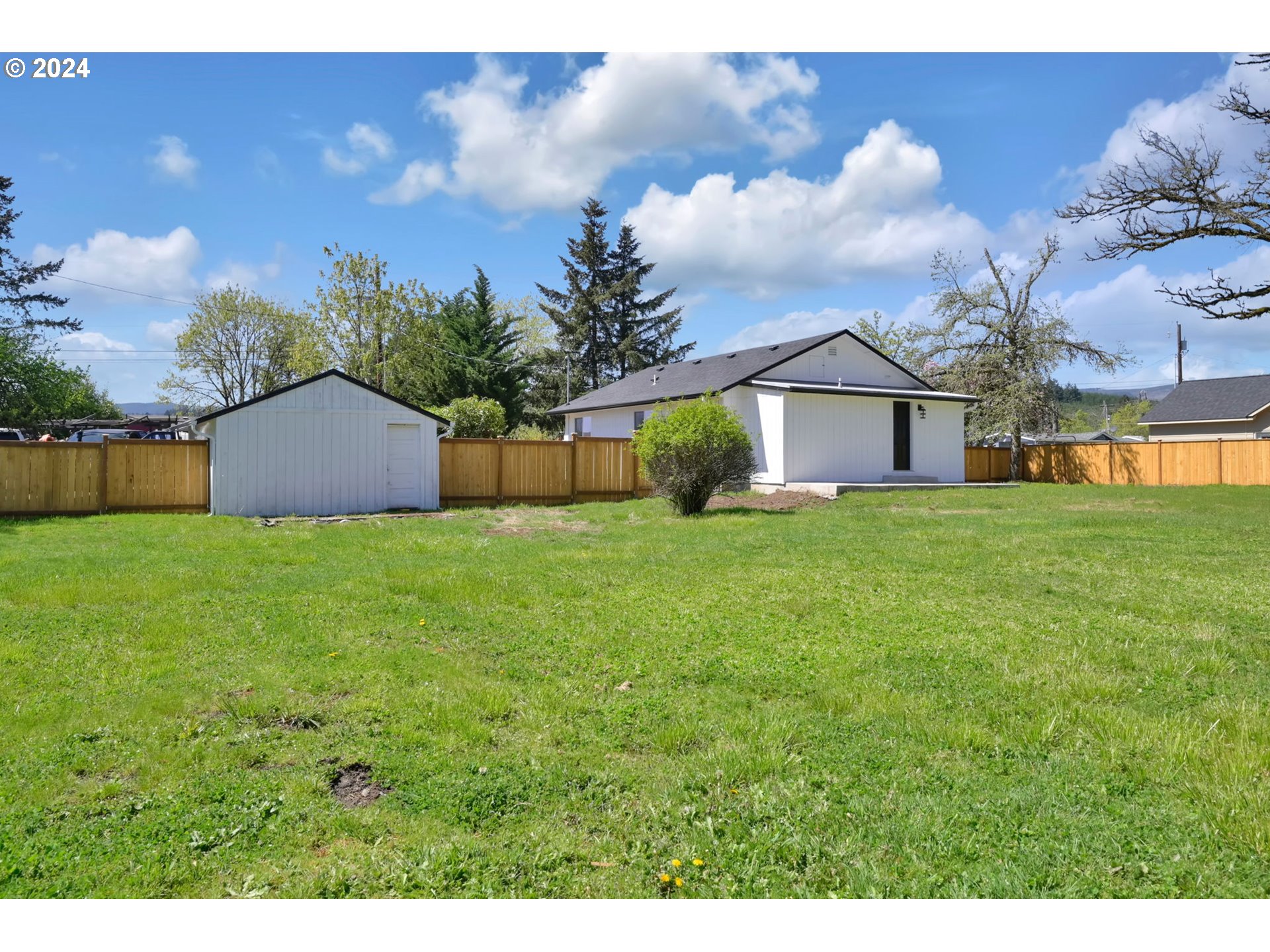 92045 Maple Lane Springfield, OR 97478 - Photo 18 of 21 a view of a house with a big yard and a large tree