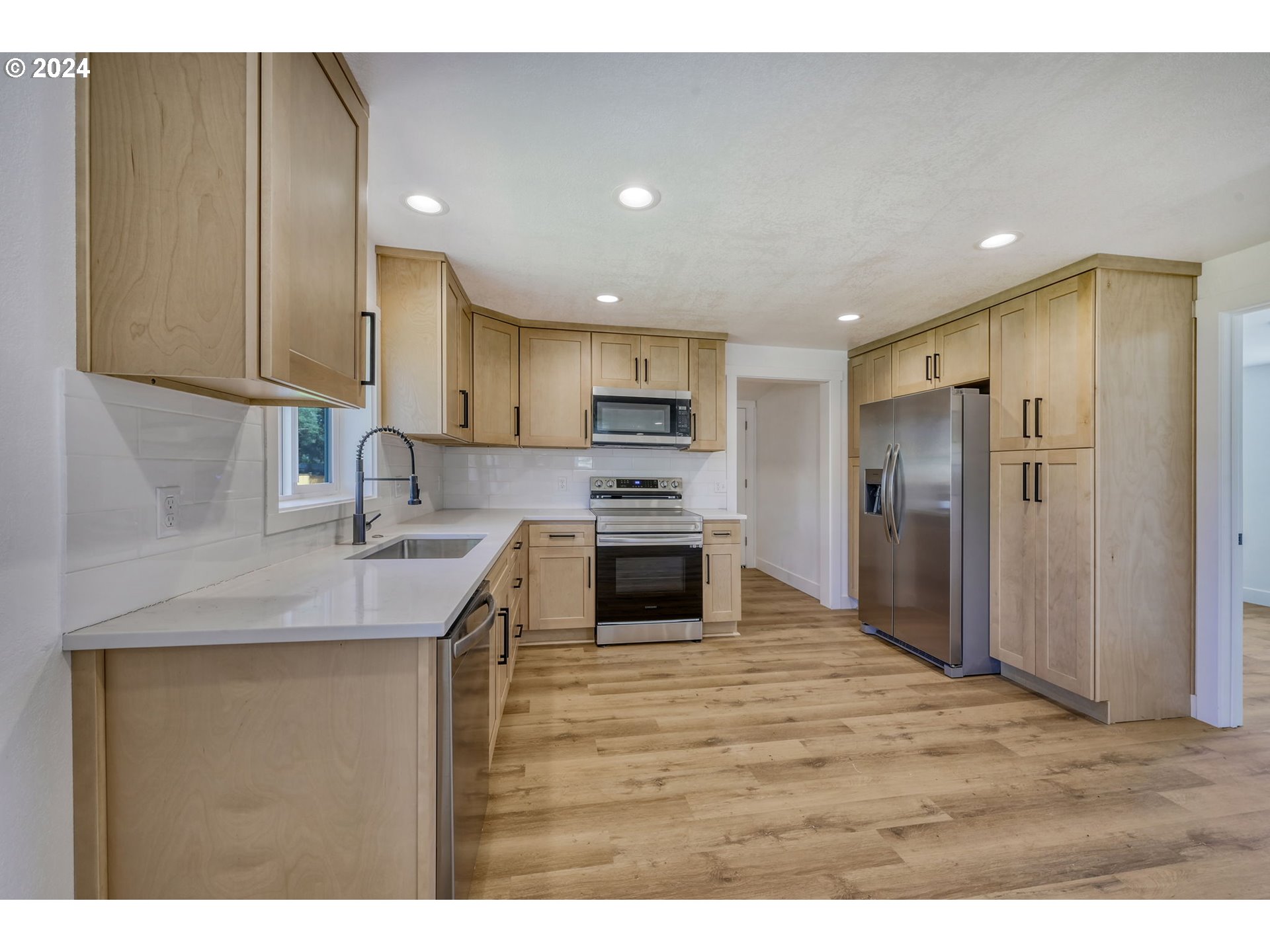 92045 Maple Lane Springfield, OR 97478 - Photo 3 of 21 a kitchen with kitchen island granite countertop a stove sink and refrigerator
