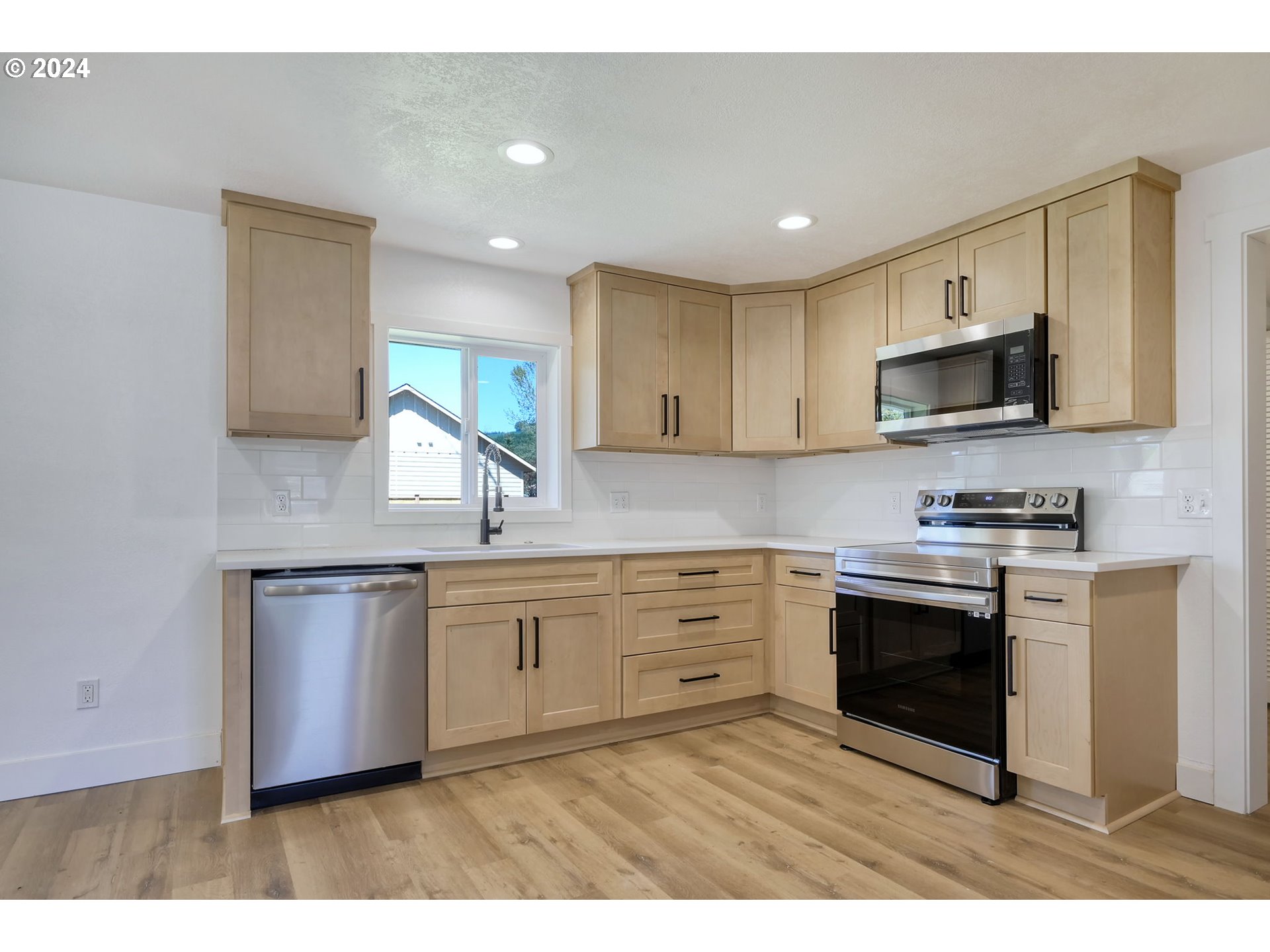 92045 Maple Lane Springfield, OR 97478 - Photo 4 of 21 a kitchen with granite countertop a stove top oven sink and cabinets