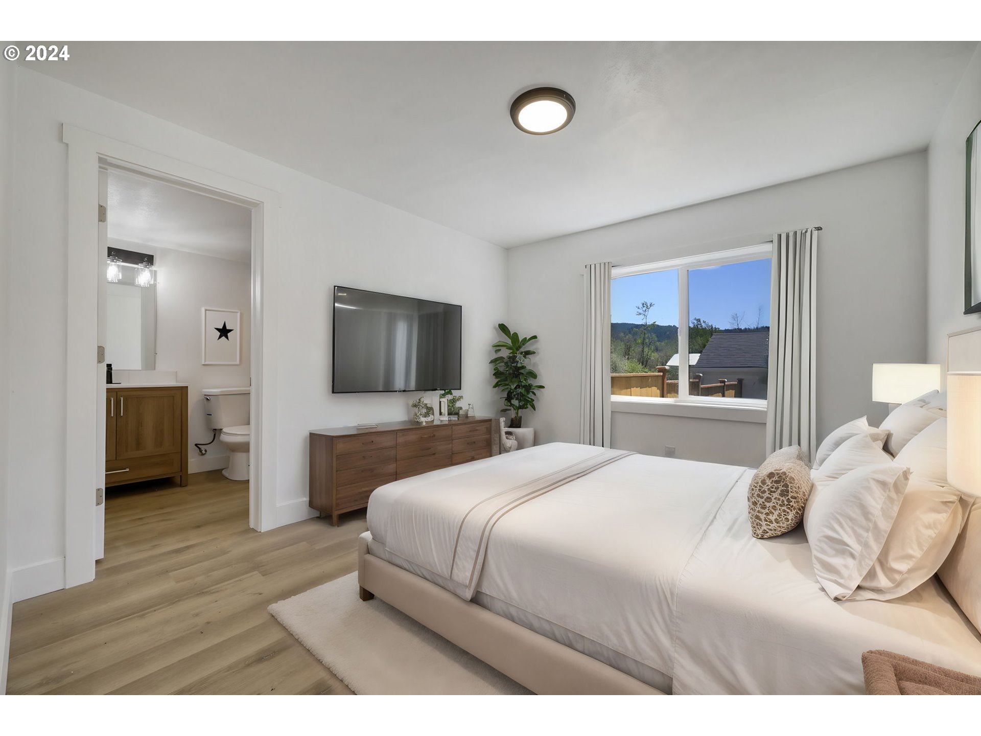 92045 Maple Lane Springfield, OR 97478 - Photo 6 of 21 a bedroom with a bed and a flat screen tv