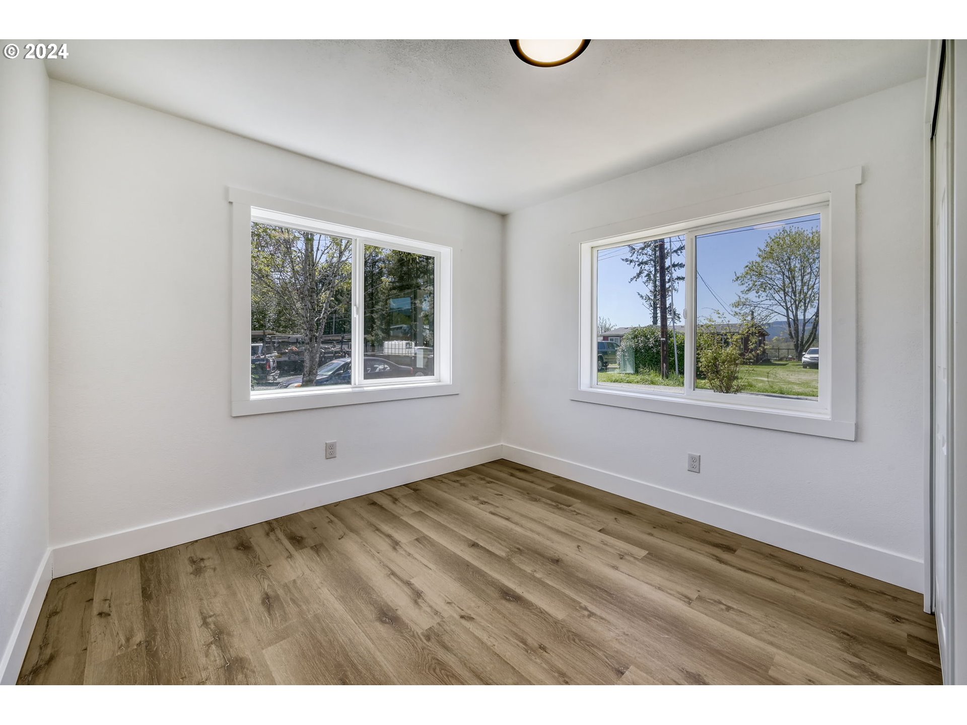 92045 Maple Lane Springfield, OR 97478 - Photo 10 of 21 a view of an empty room with a window and a ceiling fan