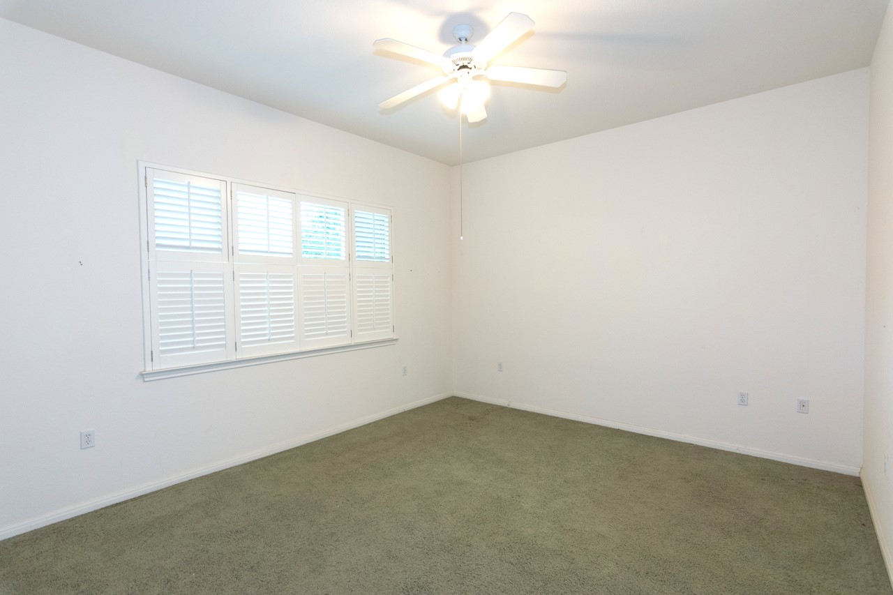 102 Harness Lane Georgetown, TX 78633 - Photo 18 of 32 an empty room with a window and a fan