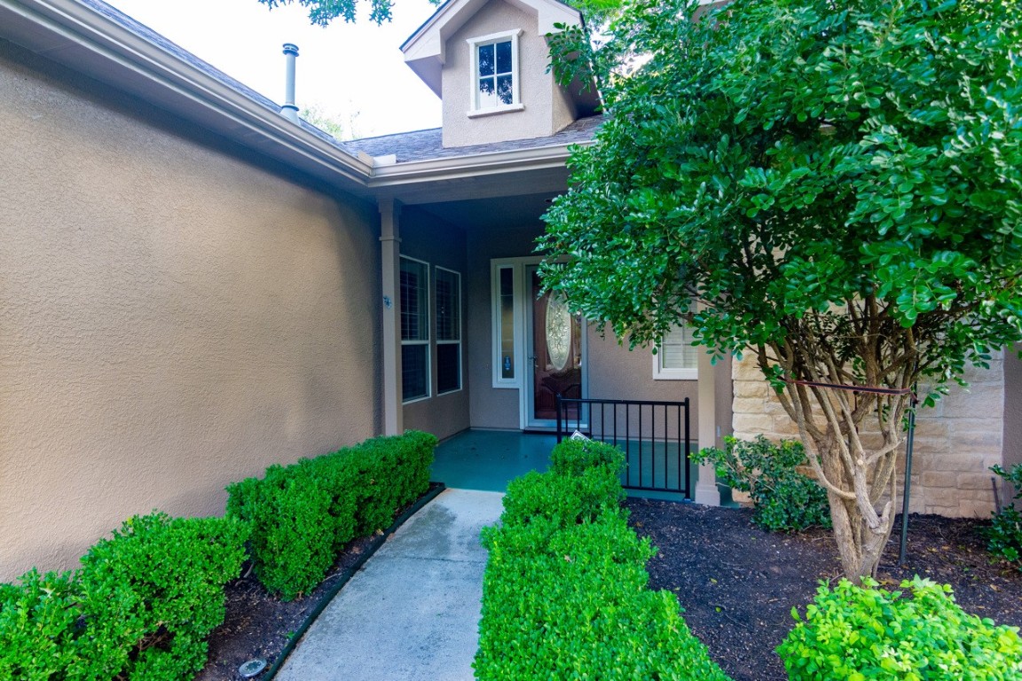 102 Harness Lane Georgetown, TX 78633 - Photo 2 of 32 View of exterior entry with stucco siding and a patio area