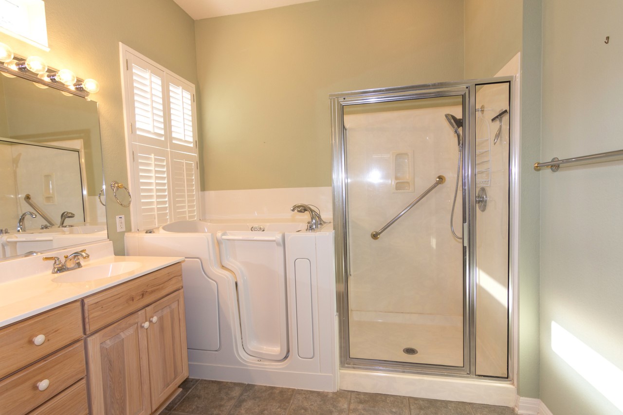 102 Harness Lane Georgetown, TX 78633 - Photo 21 of 32 a bathroom with a double vanity sink mirror and shower
