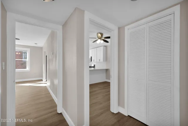 a view of an entryway with wooden floor