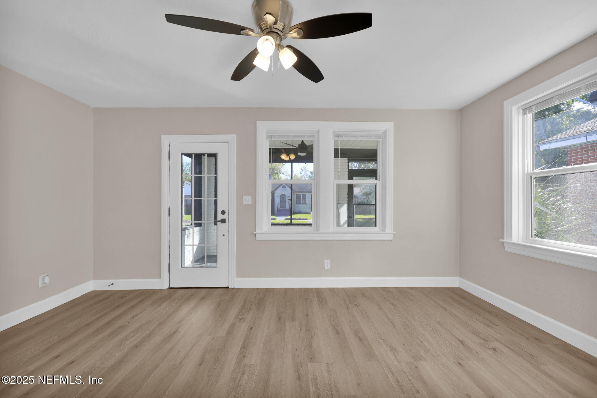 1157 West 10th Street Jacksonville, FL 32209 - Photo 6 of 23 a view of an empty room with wooden floor and a window