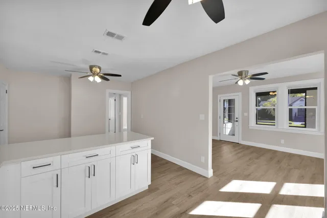 a spacious bathroom with a granite countertop sink a mirror and a vanity