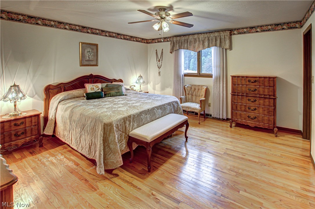 6013 Rousseau Drive Parma, OH 44129 - Photo 21 of 50 Master bedroom with ceiling fan, hardwood / wood-style flooring, and a textured ceiling
