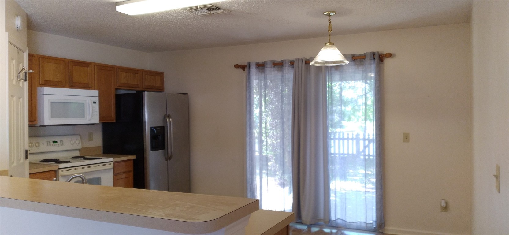 96050 Starlight Lane Yulee, FL 32097 - Photo 2 of 18 a view of a kitchen from the hallway