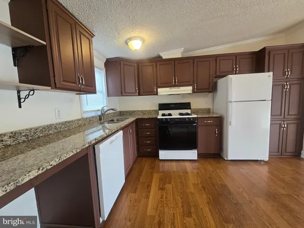 a kitchen with wooden cabinets and stainless steel appliances