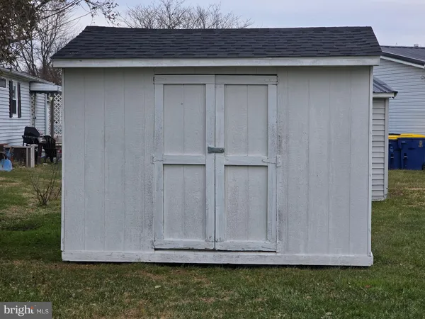 a view of backyard with wooden fence