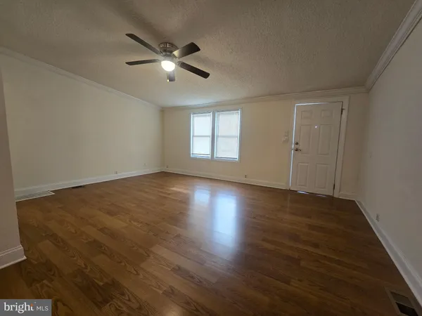 a view of wooden floor and windows in a room