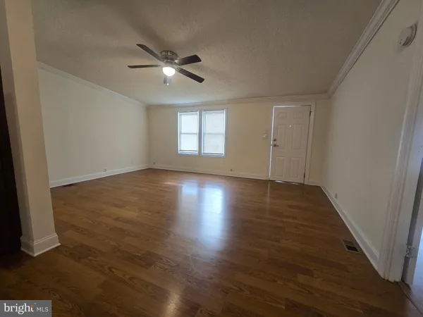 a view of wooden floor and windows in a room