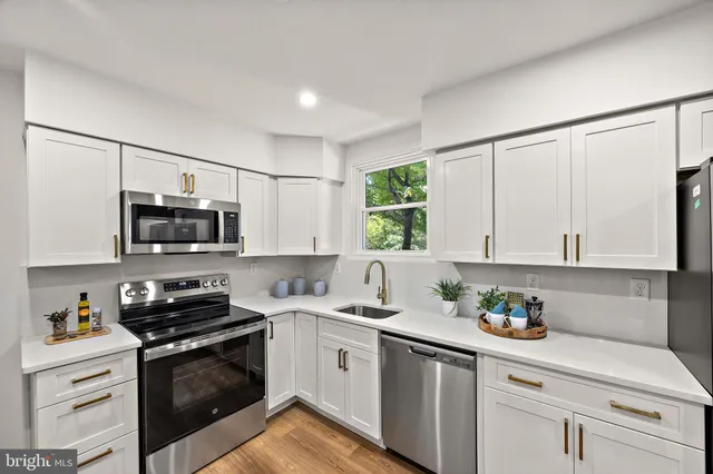 a kitchen with stainless steel appliances a refrigerator and a sink
