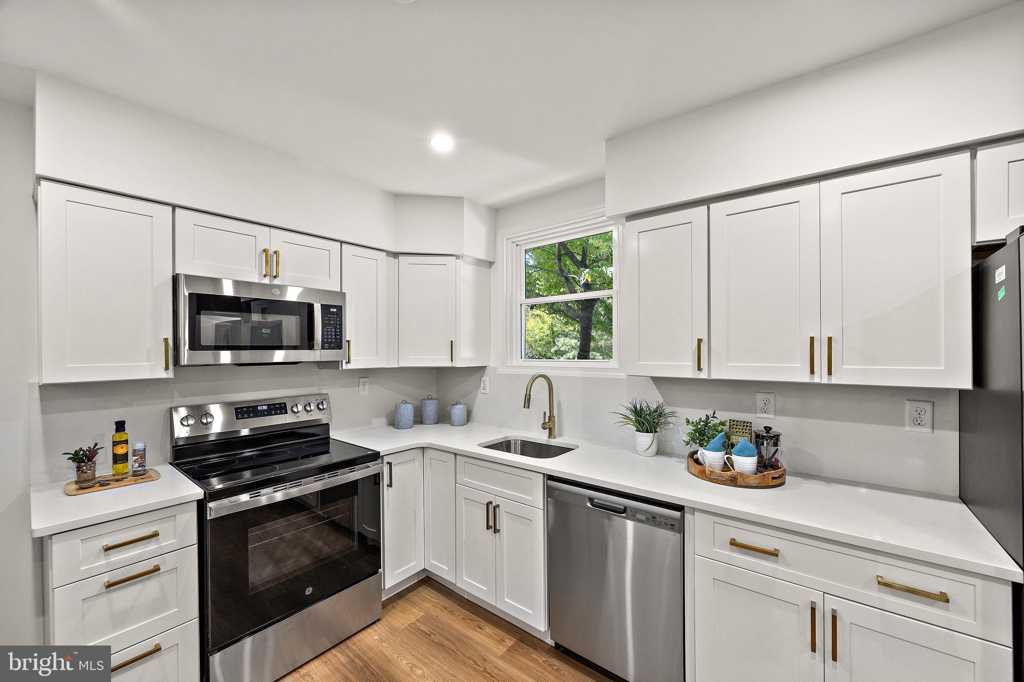 4404 Miller Road Wilmington, DE 19802 - Photo 13 of 38 a kitchen with stainless steel appliances white cabinets and a sink
