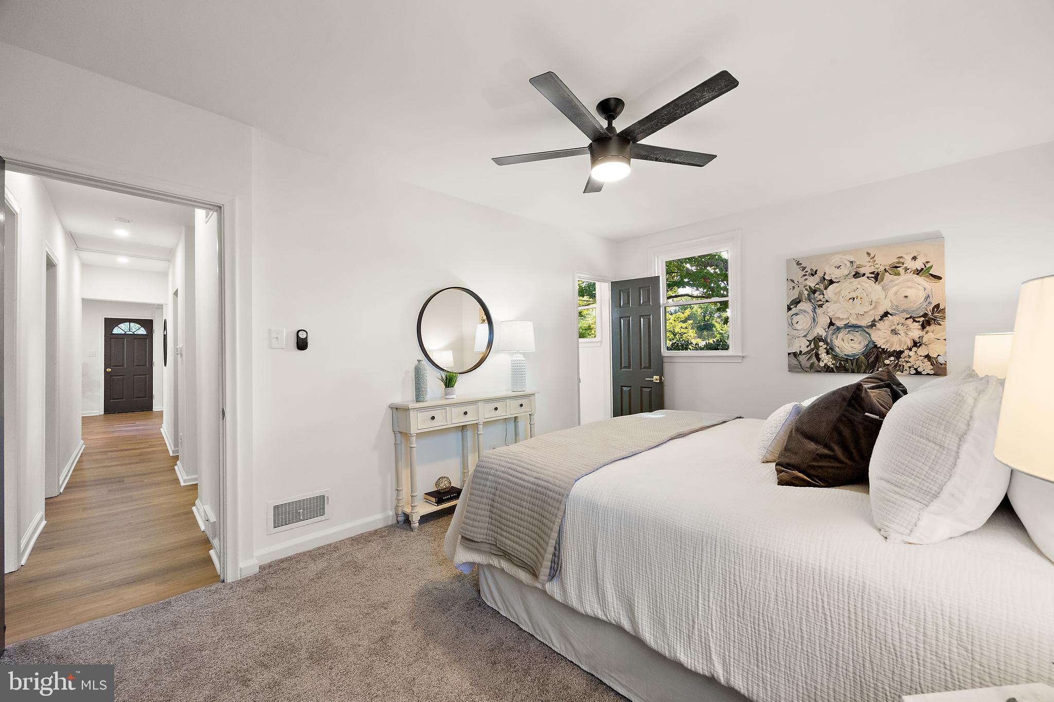 4404 Miller Road Wilmington, DE 19802 - Photo 18 of 38 a bedroom with a large bed and a chandelier