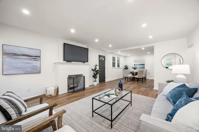 a living room with furniture potted plant and a table