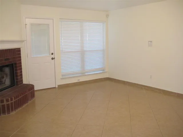 an empty room with wooden floor and a window