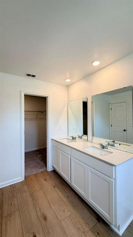 5174 Clay Whaley Road St. Cloud, FL 34772 - Photo 19 of 25 a bathroom with a double vanity sink and mirror