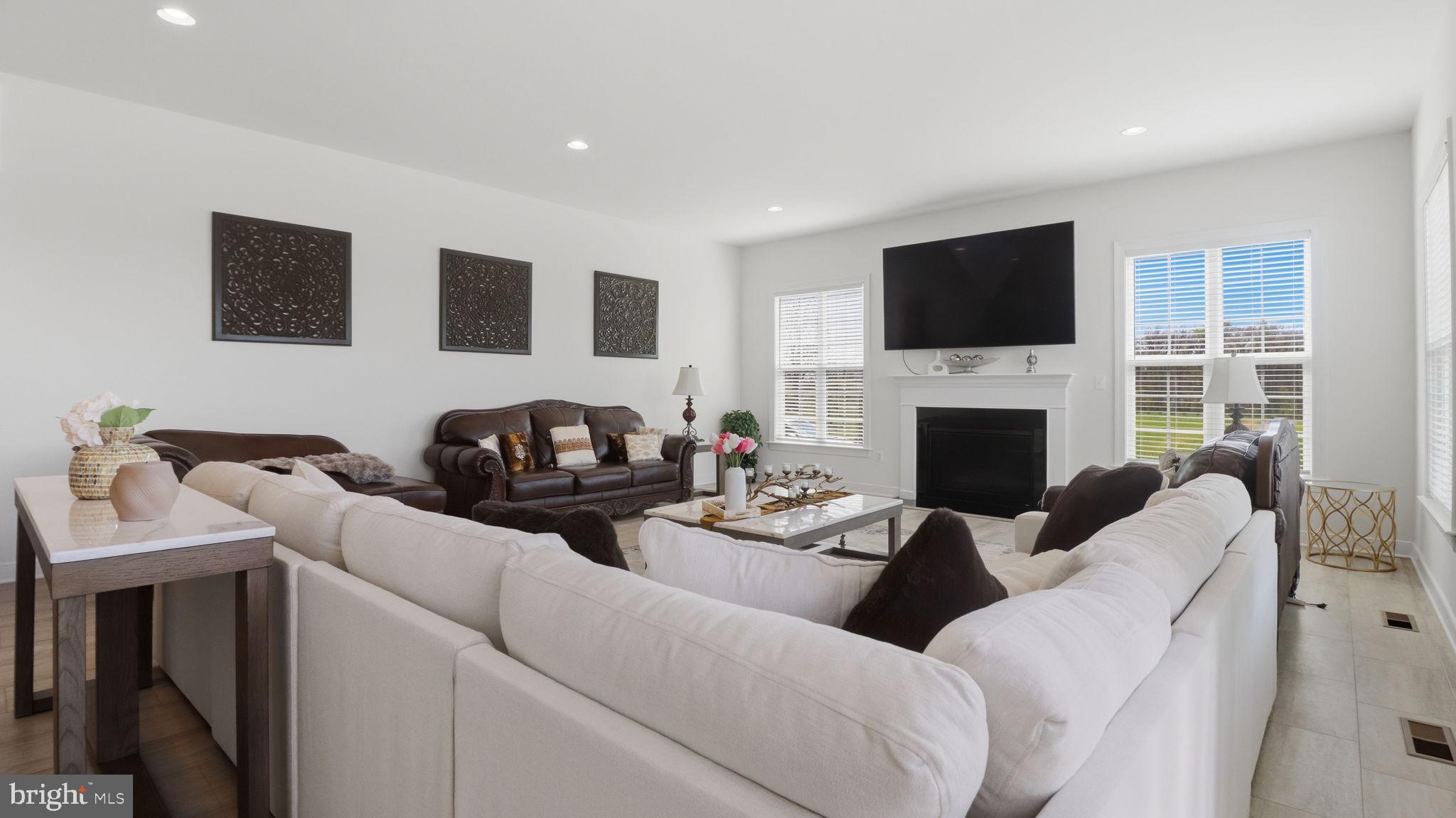 11502 Aden Road Nokesville, VA 20181 - Photo 43 of 106 a living room with furniture a fireplace and a flat screen tv