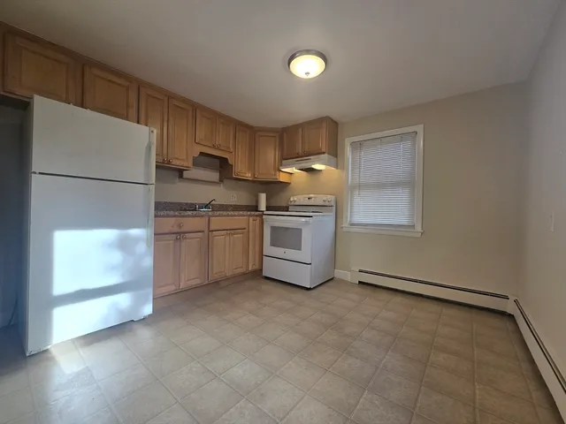 a kitchen with stainless steel appliances a refrigerator sink and cabinets
