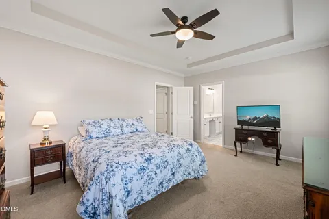 a bedroom with a bed dresser and a window