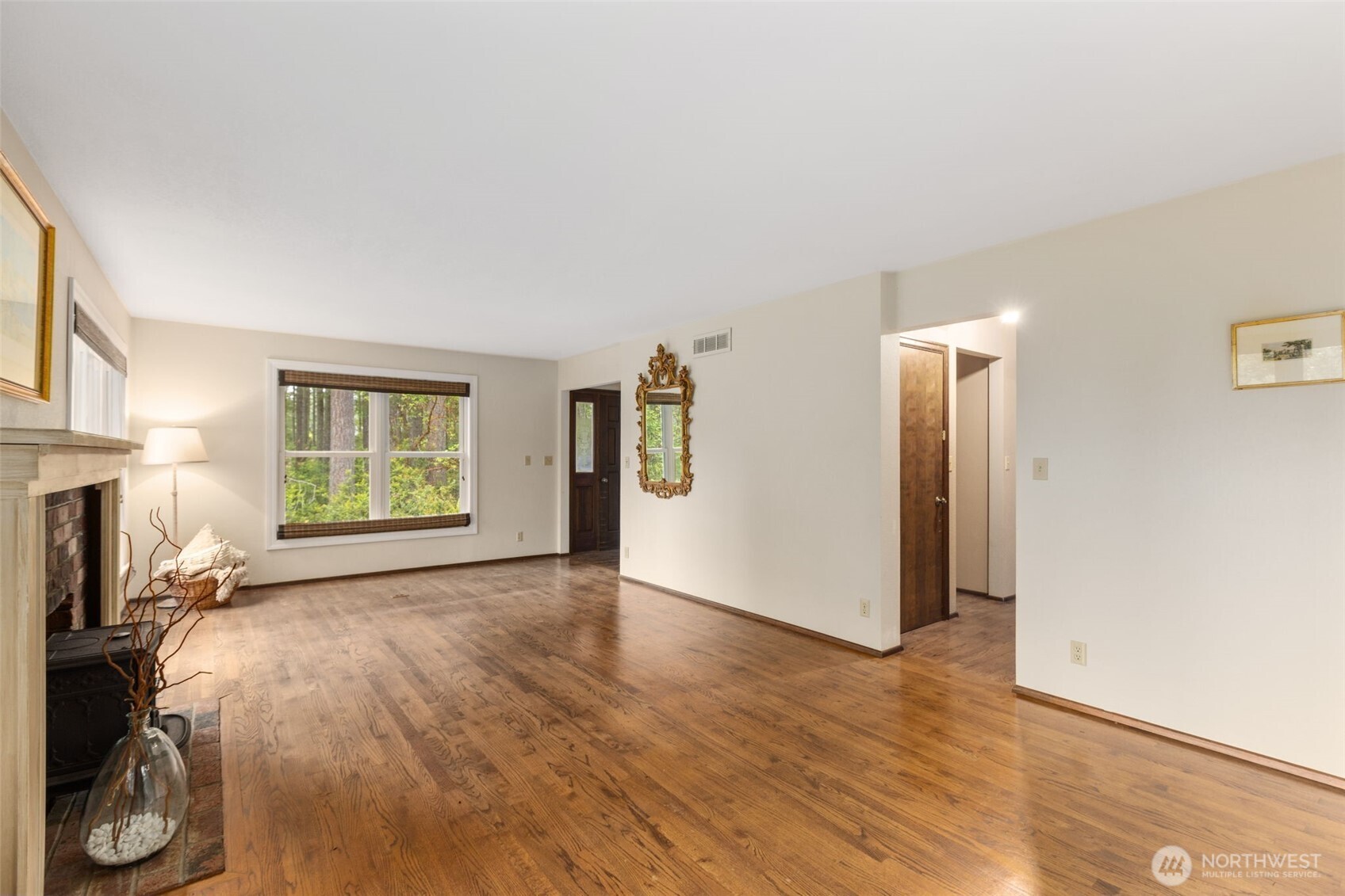 100 East Twanoh Heights Road South Belfair, WA 98528 - Photo 7 of 40 a view of livingroom with hardwood floor and a fireplace