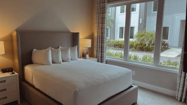 a bedroom with a large bed and a window