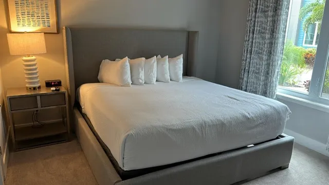 a bedroom with a bed and window