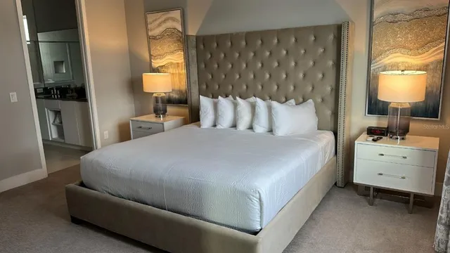 a room with a bed and a mirror on dresser