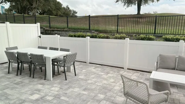a view of a patio with table and chairs