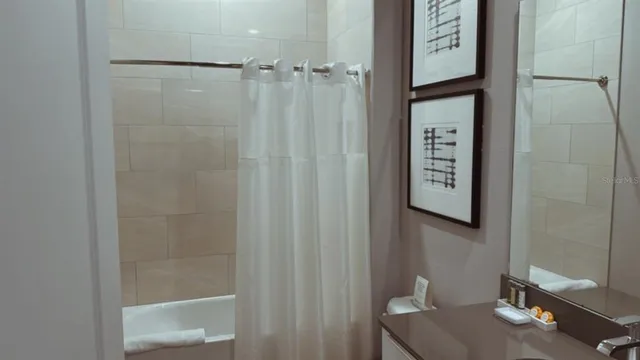 a bathroom with a shower and a sink