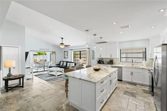 a open kitchen with stainless steel appliances granite countertop a sink and cabinets