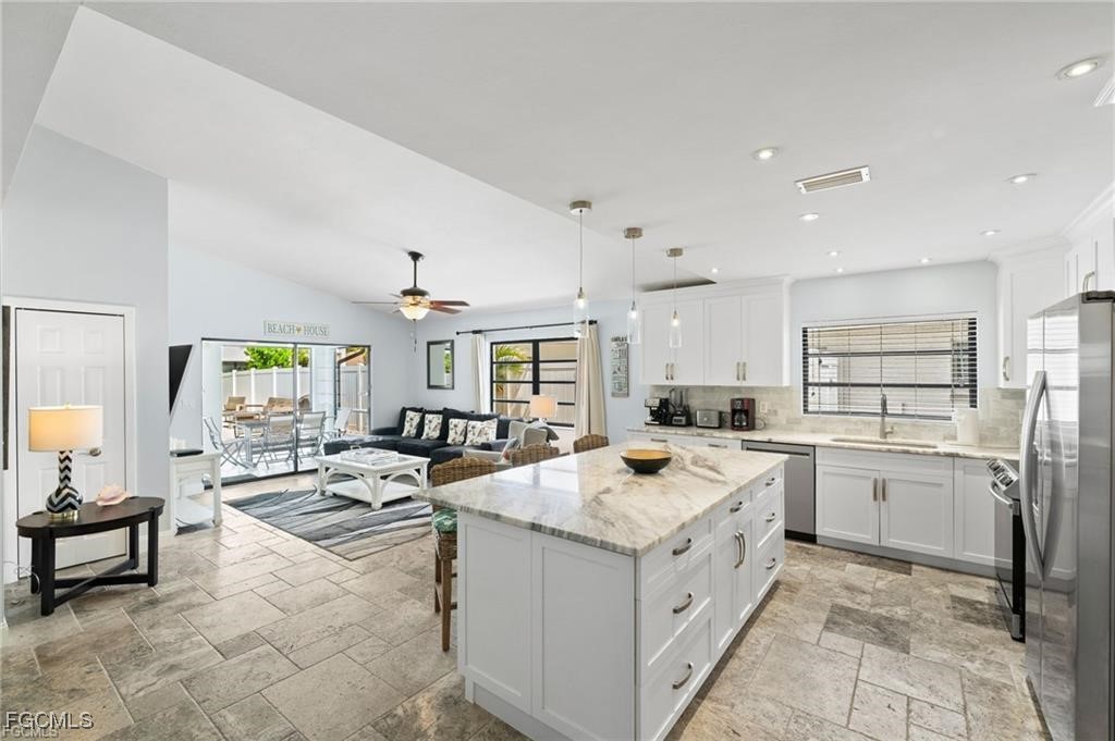 521 102nd Avenue North Naples, FL 34108 - Photo 12 of 25 a open kitchen with stainless steel appliances granite countertop a sink and cabinets