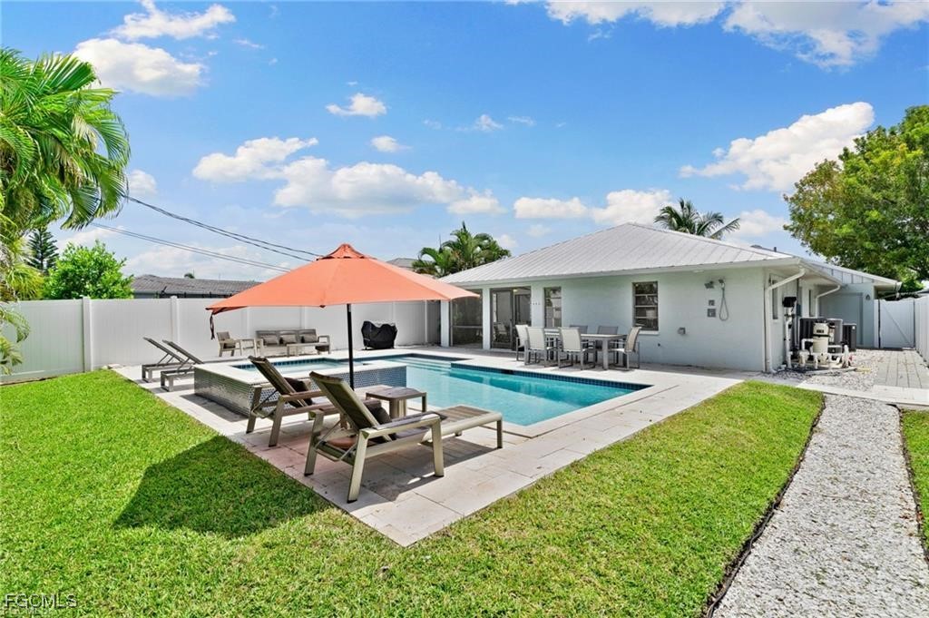 521 102nd Avenue North Naples, FL 34108 - Photo 2 of 25 a view of a house with backyard sitting area and garden