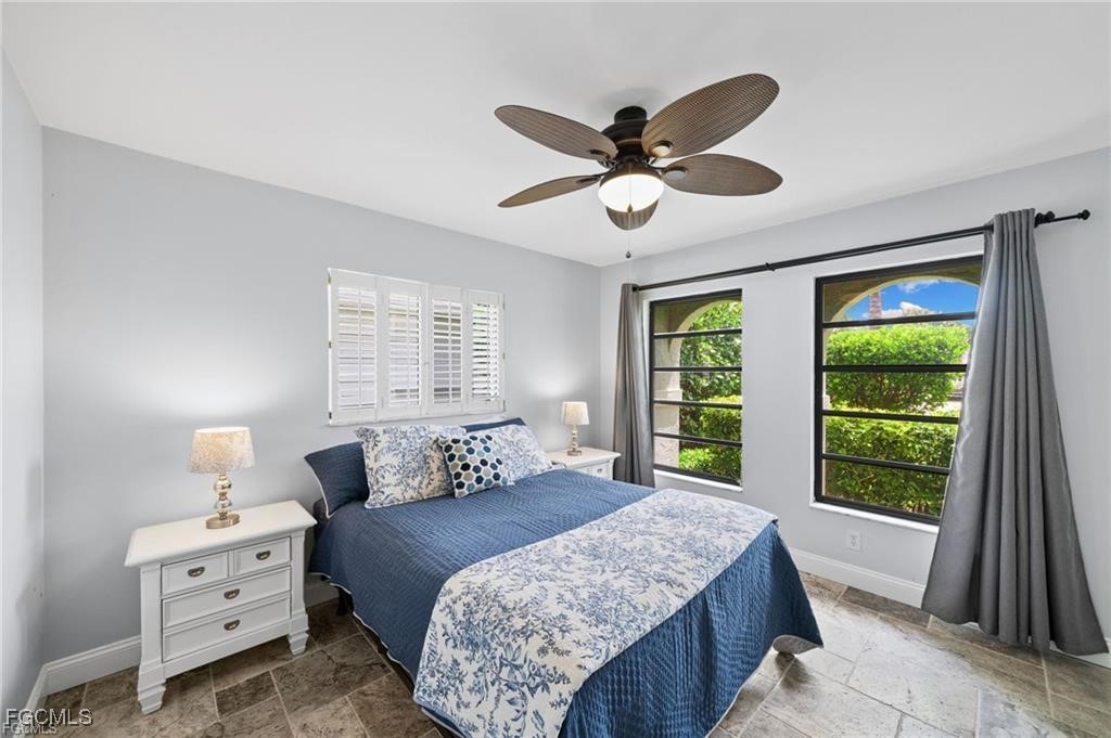 521 102nd Avenue North Naples, FL 34108 - Photo 23 of 25 a bedroom with a large bed and a large window