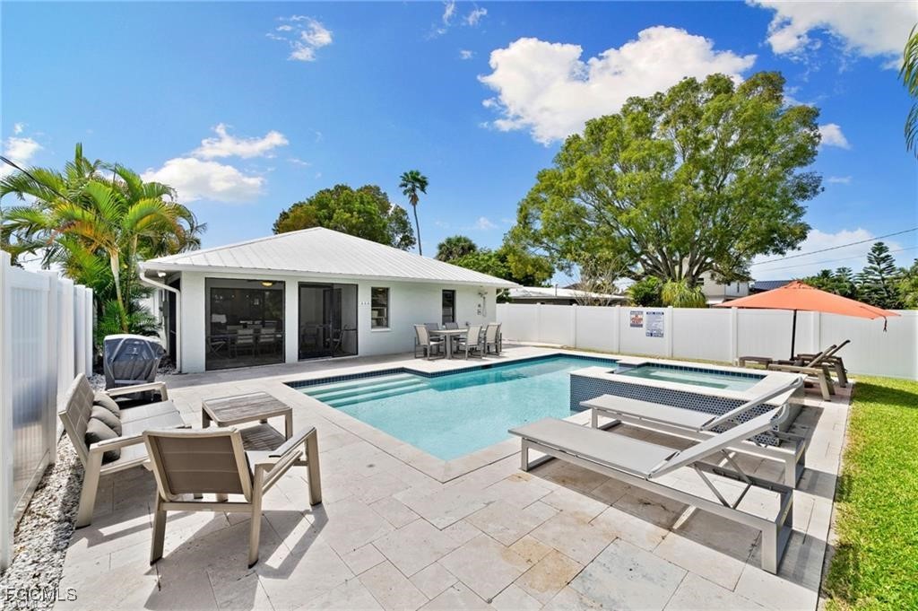 521 102nd Avenue North Naples, FL 34108 - Photo 3 of 25 a patio with a table and chairs and potted plants
