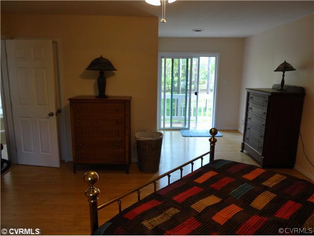 6310 Glebe Point Road Chesterfield, VA 23838 - Photo 9 of 12 a bedroom with a bed and wooden floor