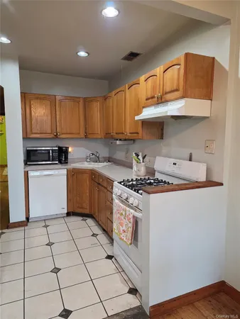 a kitchen with a stove a sink and a refrigerator