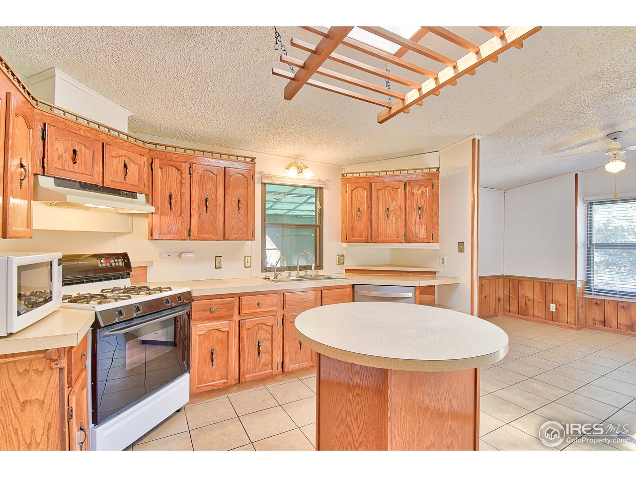 5510 Vallejo Street Denver, CO 80221 - Photo 6 of 22 a kitchen with stainless steel appliances granite countertop a stove a sink dishwasher and cabinets with wooden floor
